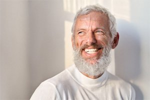 a mature man grinning with dentures in Dallas