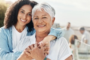 woman smiling with dentures in Dallas