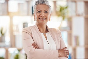 a businesswoman smiling with dentures in Dallas