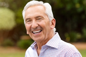 Older man with dentures smiling