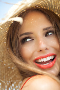 woman with a beautifully restored smile thanks to the dental crowns north dallas loves