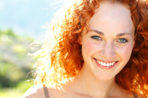 Woman with a beautiful smile thanks to the teeth whitening dentist dallas prefers