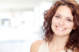 woman brunette smiling perfect teeth