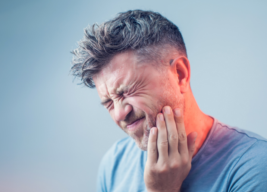 Man holding jaw in pain