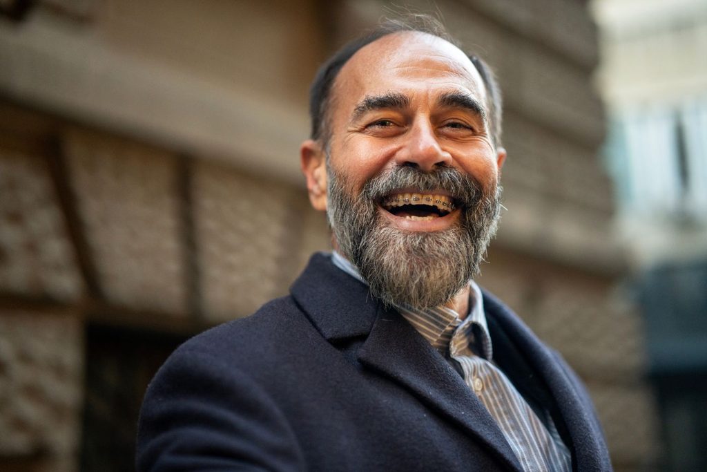 A smiling man with braces